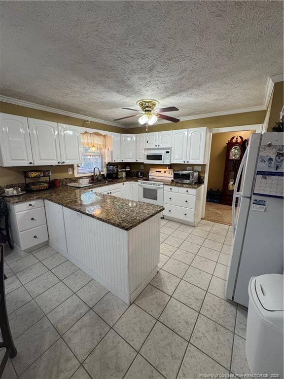 kitchen with white cabinetry, white appliances, kitchen peninsula, and ceiling fan