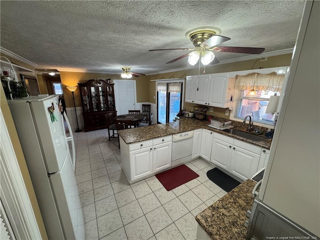 kitchen featuring white cabinetry, kitchen peninsula, white appliances, crown molding, and sink