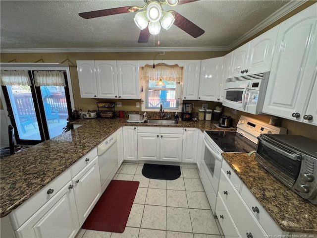 kitchen featuring sink, white appliances, and white cabinets