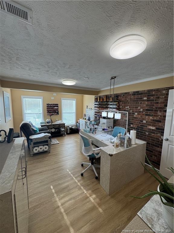 home office featuring a textured ceiling and light hardwood / wood-style flooring