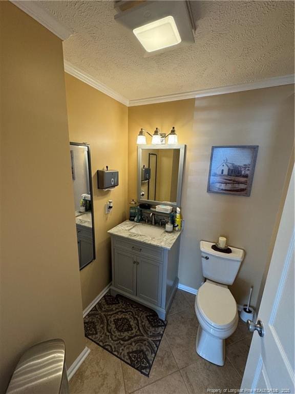 bathroom featuring a textured ceiling, tile patterned flooring, ornamental molding, and vanity