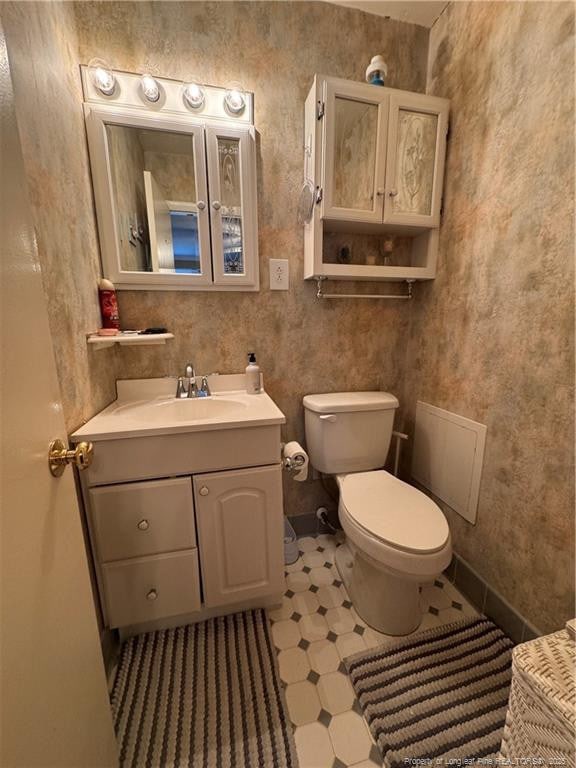 bathroom with toilet and vanity