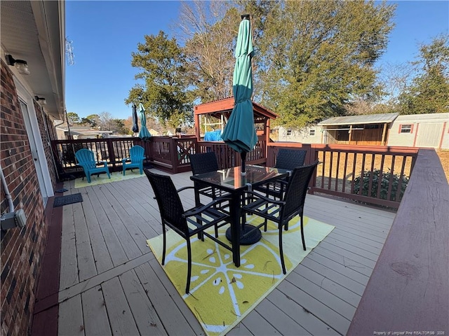 wooden deck featuring a storage unit