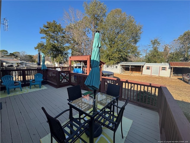 wooden deck featuring a storage shed