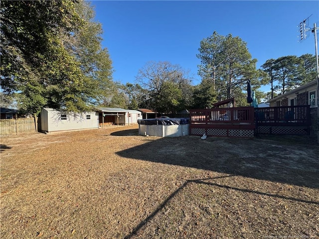 view of yard with a storage shed and a deck