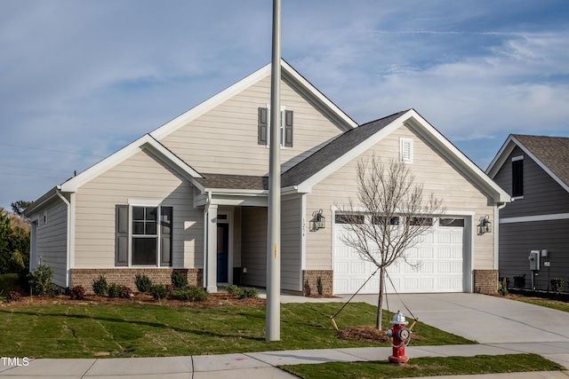 view of front of property with a garage and a front lawn