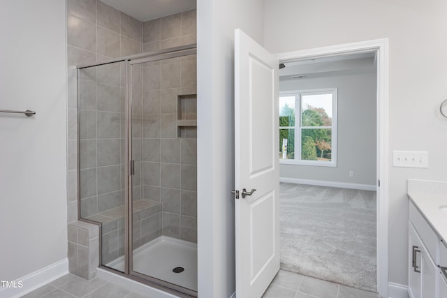 bathroom with vanity, tile patterned floors, and walk in shower