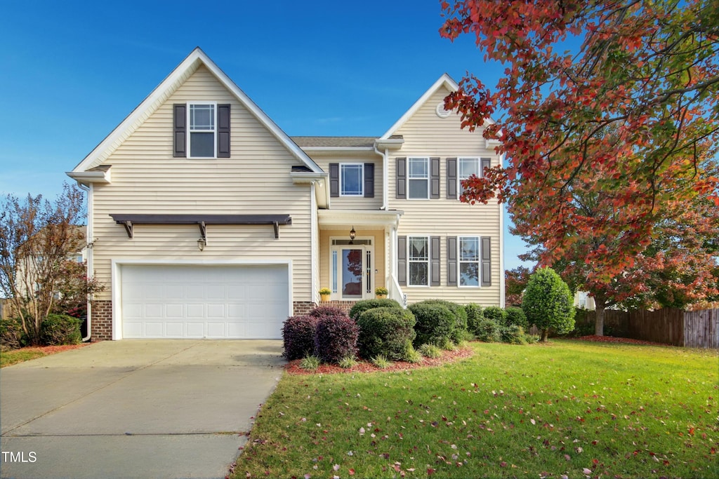 front of property with a garage and a front lawn