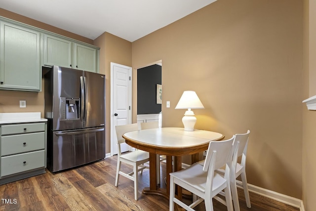 dining area with dark hardwood / wood-style flooring