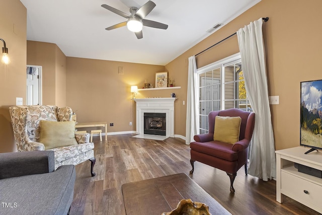 sitting room with ceiling fan and dark hardwood / wood-style flooring