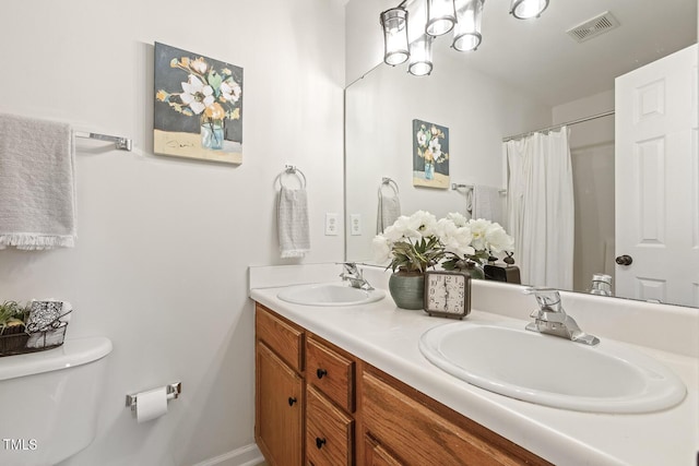 bathroom featuring toilet and vanity