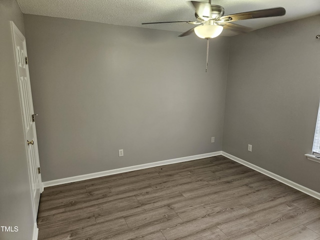 spare room with a textured ceiling, ceiling fan, and light hardwood / wood-style flooring