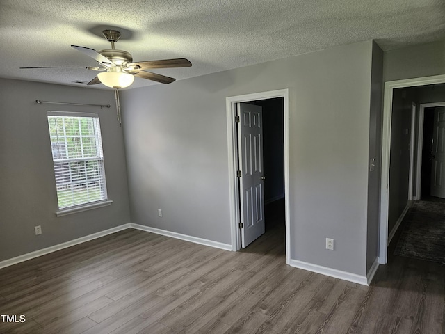 spare room with a textured ceiling, ceiling fan, and wood-type flooring