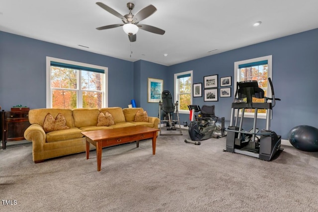 living room with ceiling fan and carpet flooring