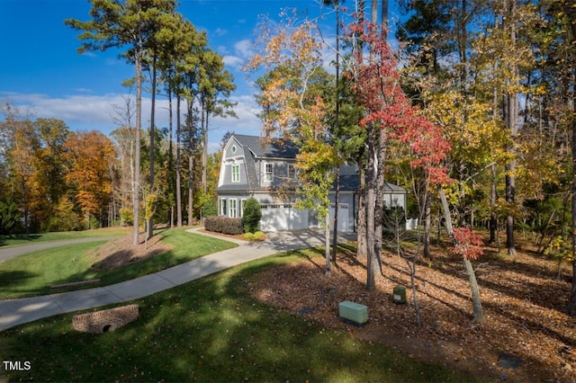 view of front facade with a garage and a front lawn