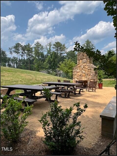 view of community with a yard and a patio area