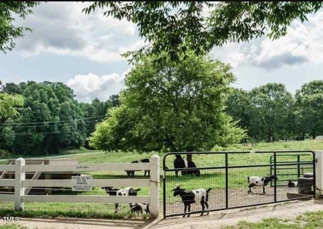 view of gate featuring a yard and a rural view