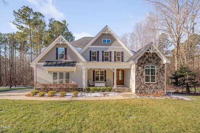 craftsman inspired home with covered porch and a front yard