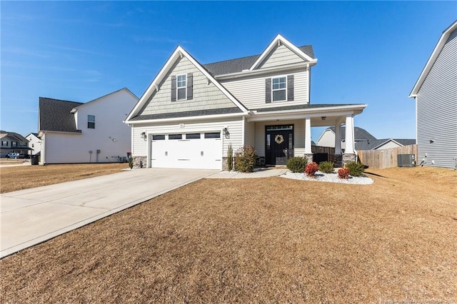 craftsman-style home featuring a garage, a front yard, a porch, and central AC