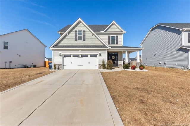 craftsman-style home with a porch, a garage, and a front lawn