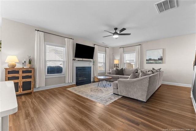 living room with wood-type flooring and ceiling fan