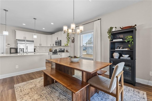 dining room featuring an inviting chandelier and dark hardwood / wood-style flooring