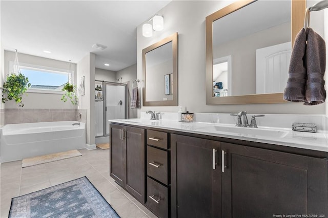 bathroom featuring vanity, shower with separate bathtub, and tile patterned flooring