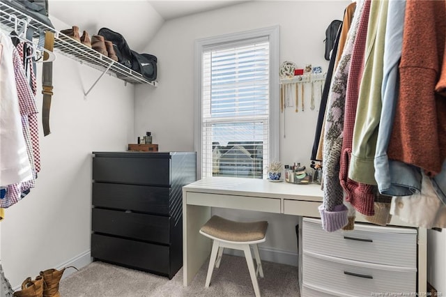 walk in closet with lofted ceiling