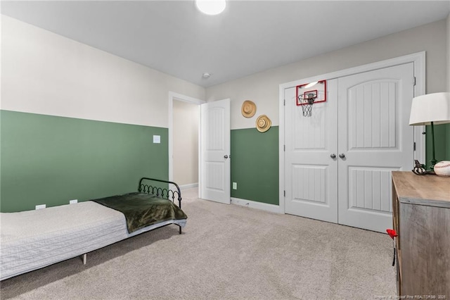 bedroom featuring light carpet and a closet