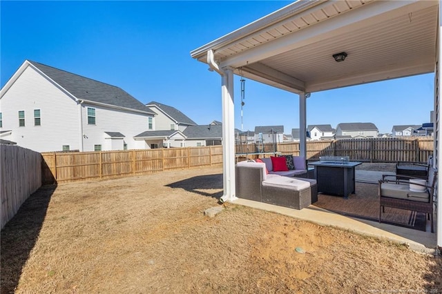 view of yard featuring a patio and an outdoor living space with a fire pit