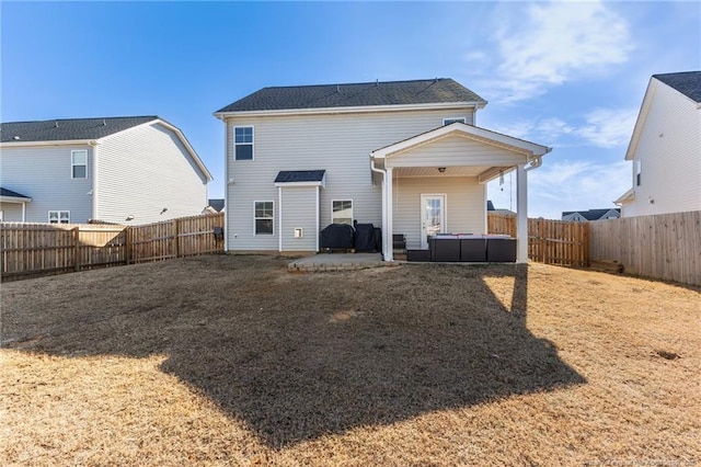 back of house with a lawn and a patio area