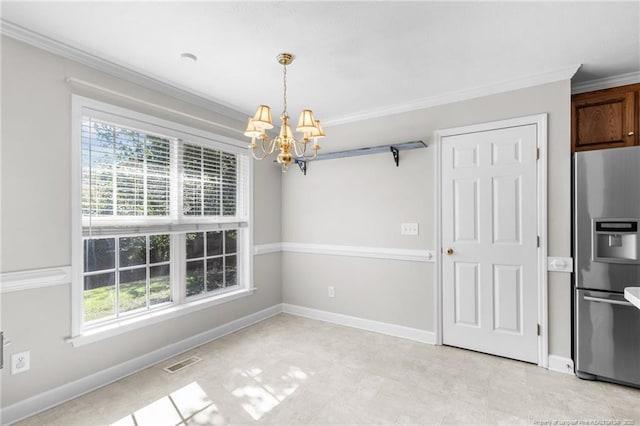 unfurnished dining area with a chandelier and crown molding