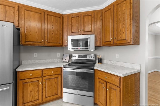 kitchen featuring appliances with stainless steel finishes and crown molding