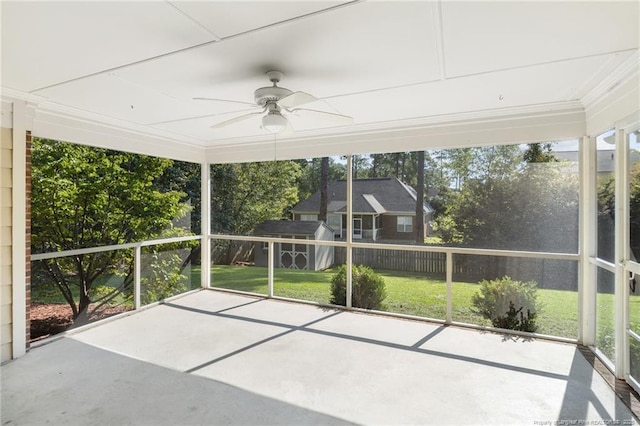 unfurnished sunroom with ceiling fan