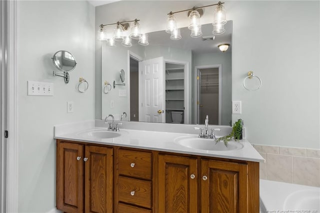 bathroom with a washtub and vanity