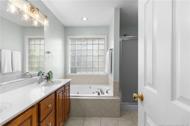 bathroom featuring independent shower and bath, tile patterned floors, and vanity