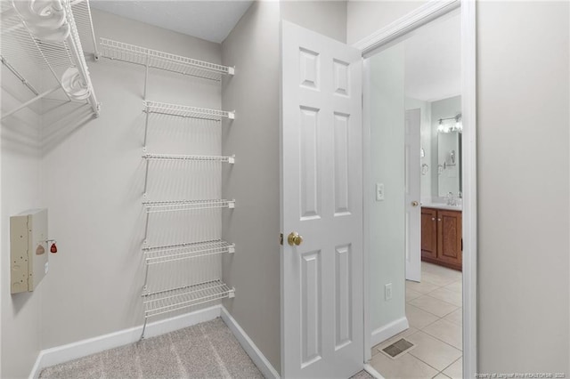 spacious closet featuring light tile patterned floors