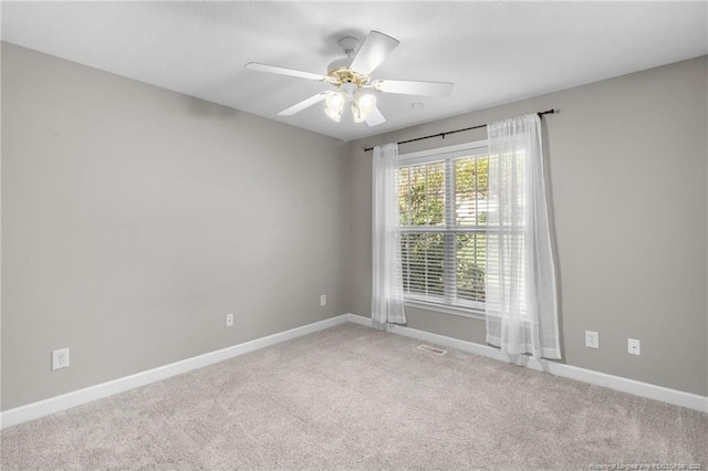 carpeted spare room with ceiling fan