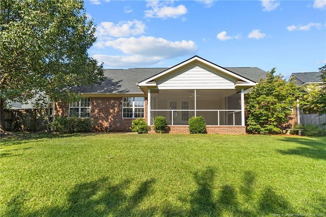 back of house featuring a yard and a sunroom