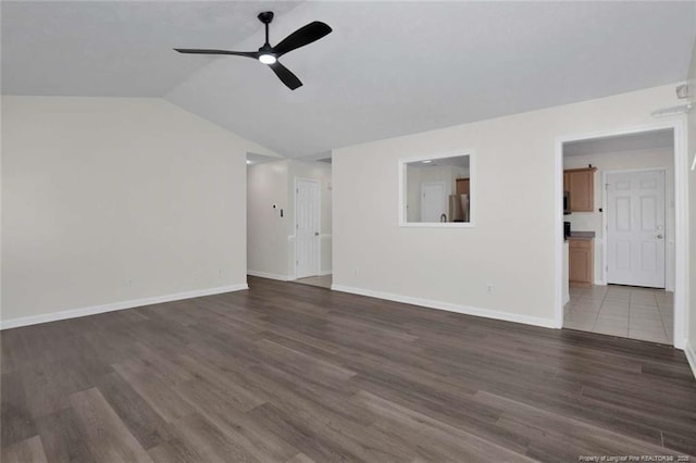 unfurnished living room featuring ceiling fan, dark hardwood / wood-style flooring, and lofted ceiling