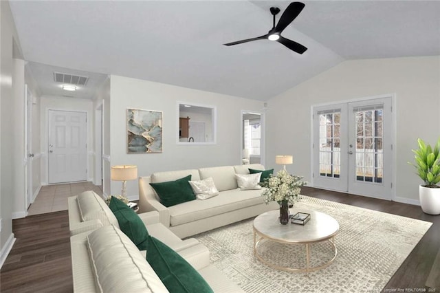 living room with ceiling fan, dark hardwood / wood-style floors, french doors, and vaulted ceiling