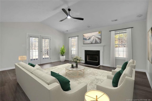 living room with lofted ceiling, ceiling fan, dark hardwood / wood-style flooring, and french doors