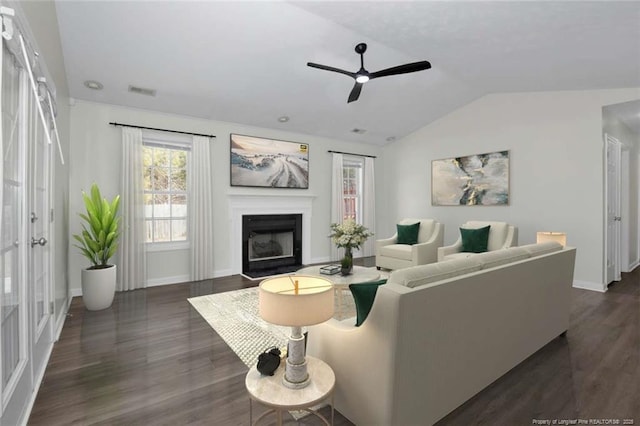 living room featuring vaulted ceiling, ceiling fan, and dark hardwood / wood-style floors