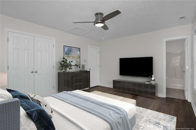 bedroom featuring ceiling fan, a closet, connected bathroom, and dark hardwood / wood-style floors