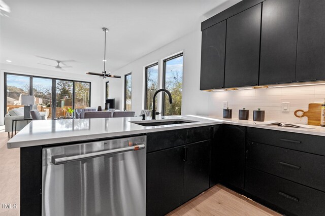 808 Culpepper Ln, Raleigh, NC 27610 - kitchen with sink, dishwasher, decorative backsplash, kitchen peninsula, and light wood-type flooring