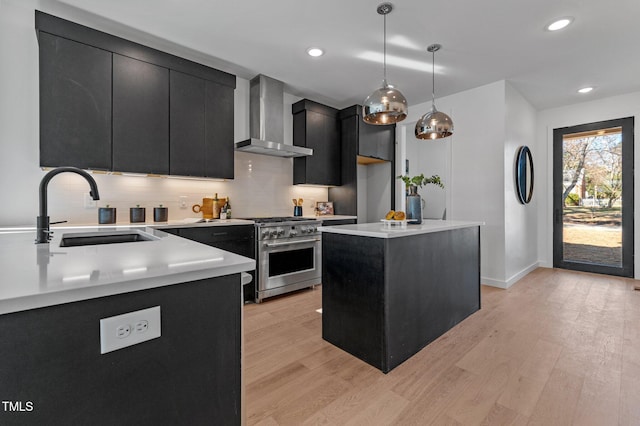 808 Culpepper Ln, Raleigh, NC 27610 - kitchen featuring sink, high end range, hanging light fixtures, a center island, and wall chimney range hood