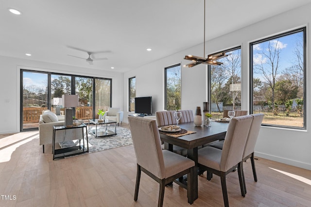 808 Culpepper Ln, Raleigh, NC 27610 - dining room featuring ceiling fan with notable chandelier, light hardwood / wood-style flooring, and plenty of natural light