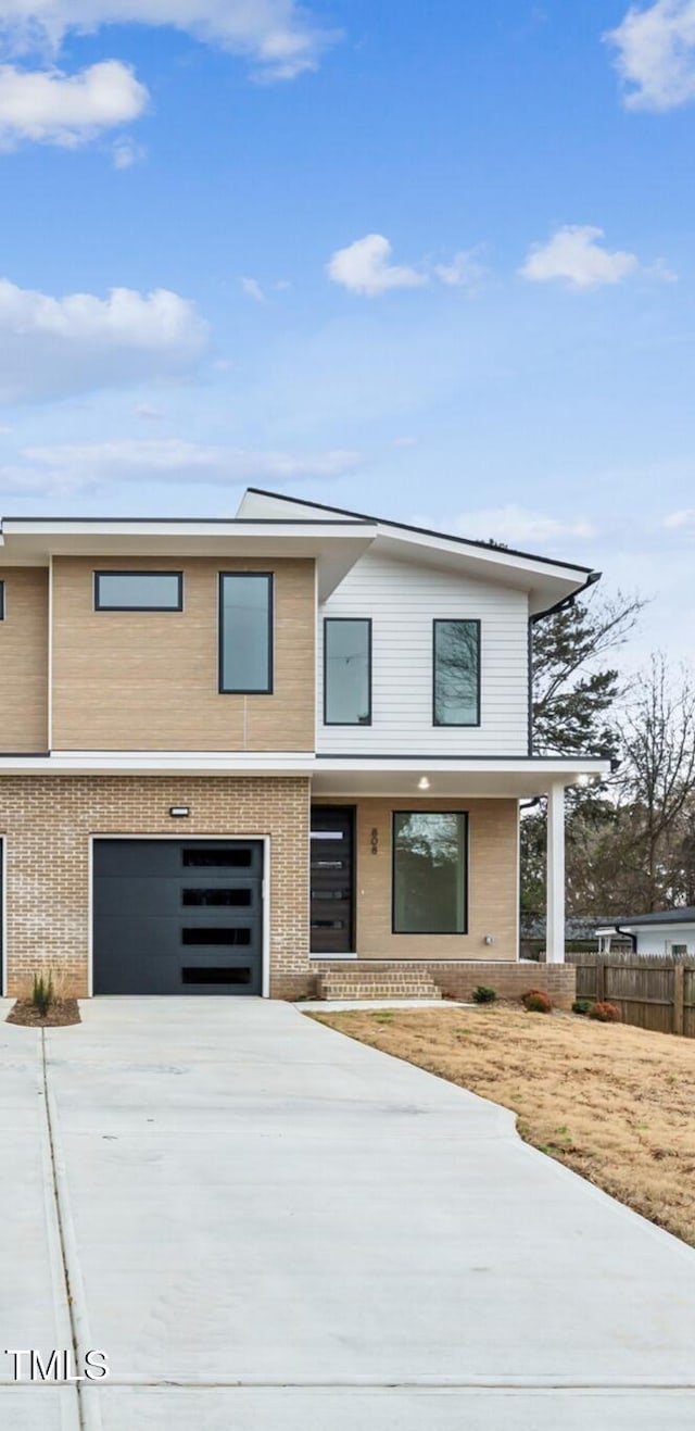 view of front of home featuring a garage and a porch