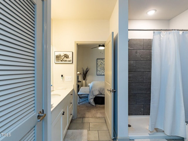 bathroom featuring tile patterned flooring, tiled shower, a ceiling fan, ensuite bathroom, and vanity