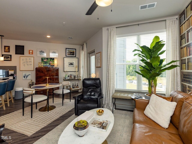 living room with ceiling fan, wood finished floors, and recessed lighting